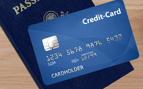 Credit card with its serial numbers on its shown side on top of a passport